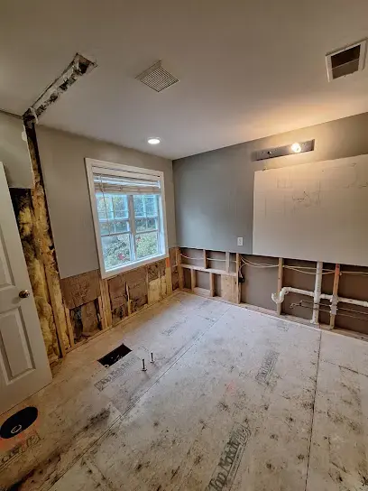 Bedroom with the lower drywall cut away and the subfloor exposed during drying