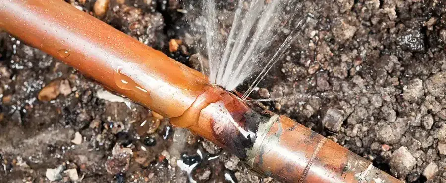 Water spraying from a split in a copper pipe